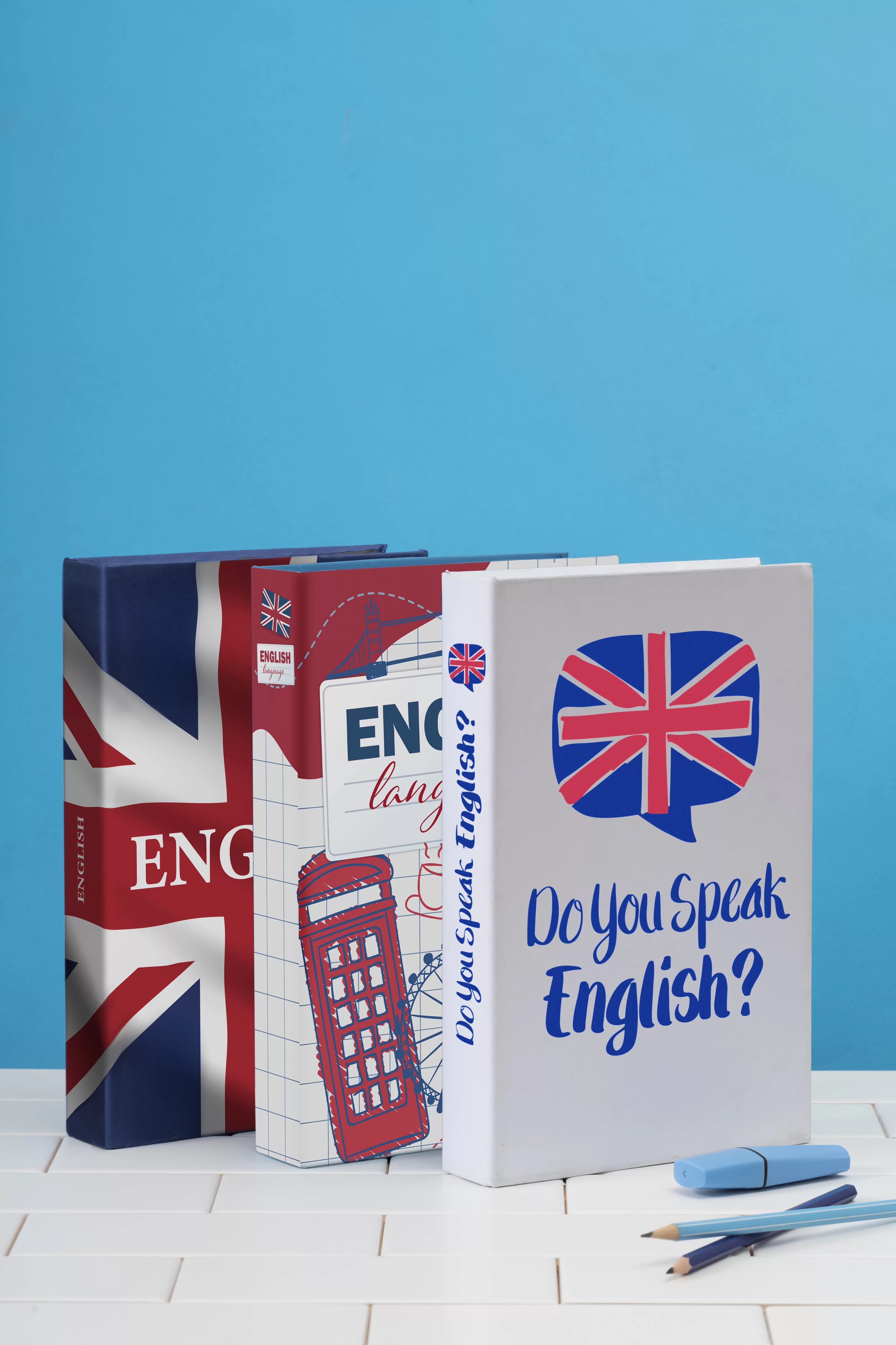 english-books-arrangement-white-surface-min